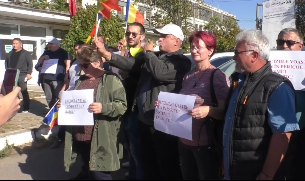 Angajați ai CET Iași cu pancarte la un protest în fața uzinei